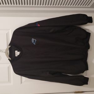 Sport Haley black windshirt with Carolina Panthers logo and slit pockets.
